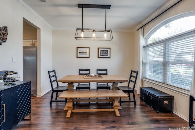 dining area featuring dark hardwood / wood-style flooring, crown molding, and an inviting chandelier