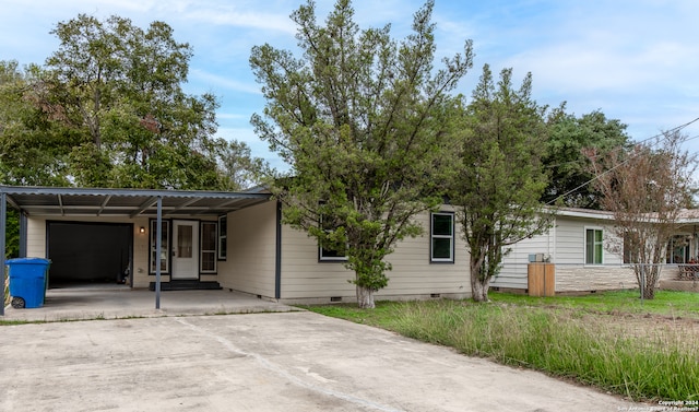 view of front of property with a carport and a garage