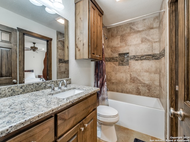 full bathroom with tile floors, tiled shower / bath combo, ceiling fan, toilet, and vanity