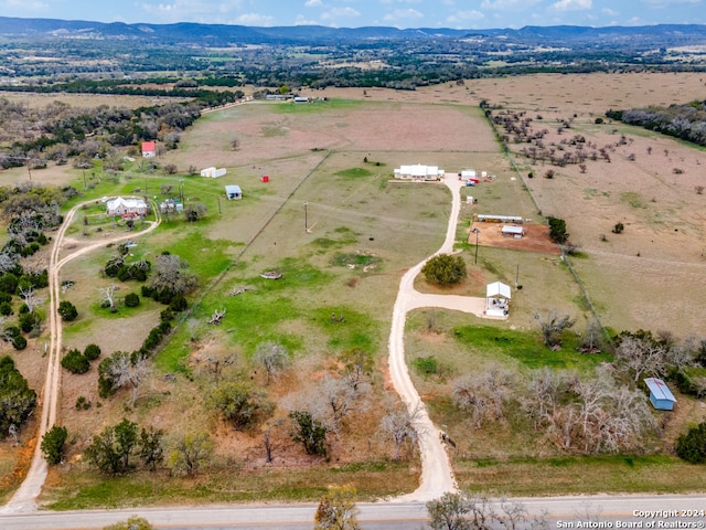 birds eye view of property featuring a mountain view and a rural view