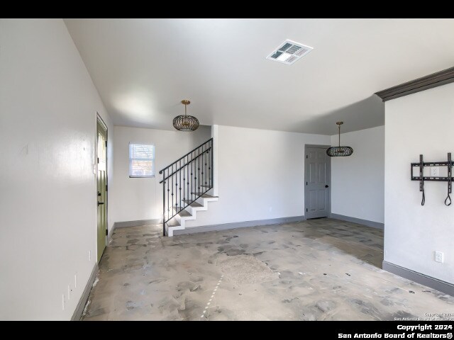 unfurnished living room with concrete flooring