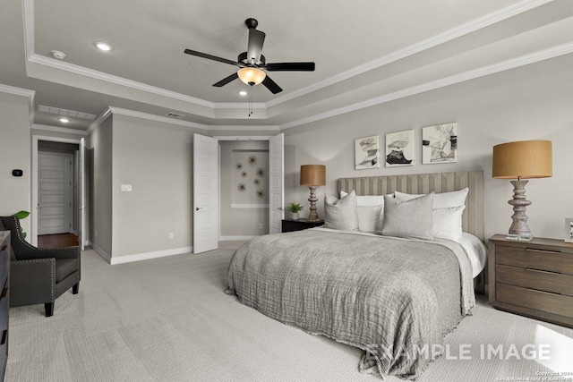 carpeted bedroom featuring a raised ceiling, ornamental molding, and ceiling fan