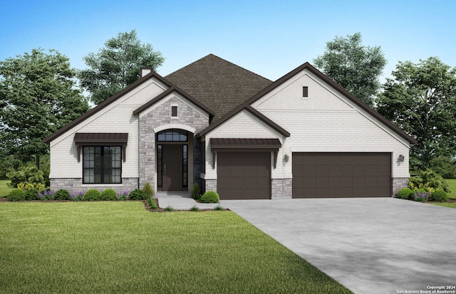 view of front of property featuring a front yard and a garage