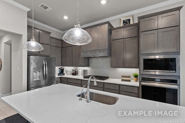 kitchen featuring pendant lighting, stainless steel appliances, backsplash, premium range hood, and light stone countertops