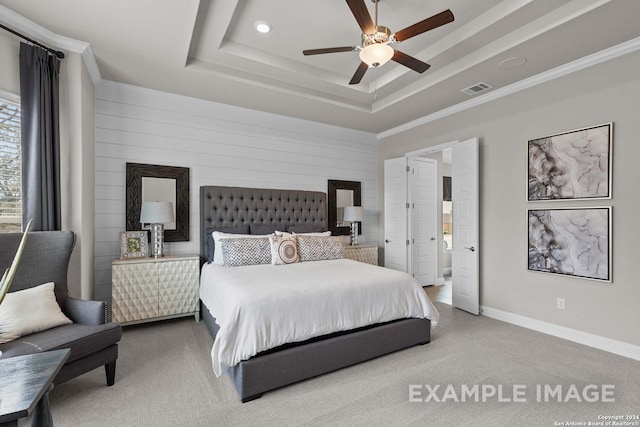 carpeted bedroom featuring ceiling fan and a tray ceiling