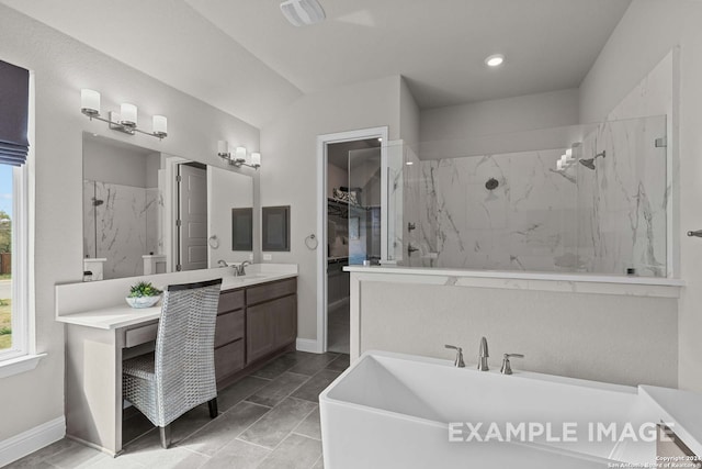 bathroom with oversized vanity, tile flooring, and independent shower and bath