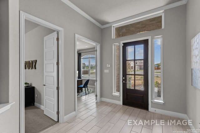 carpeted foyer entrance with crown molding