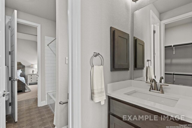 bathroom featuring vanity, tile flooring, and  shower combination