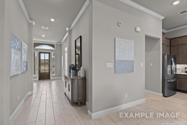 corridor with ornamental molding and light wood-type flooring