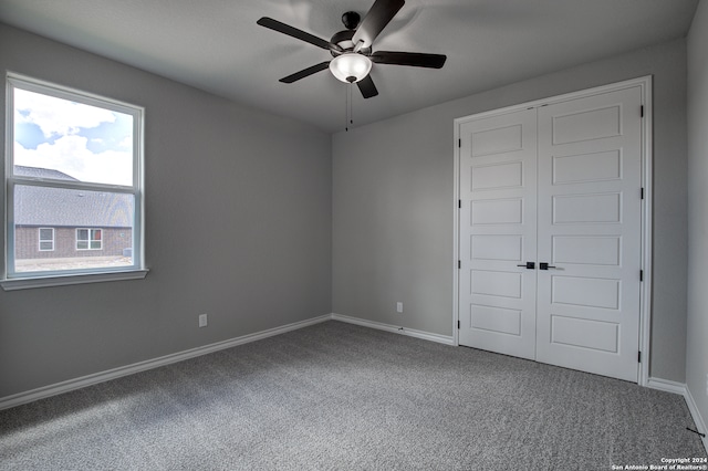 unfurnished bedroom featuring ceiling fan, carpet floors, and a closet