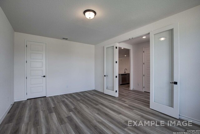 unfurnished bedroom with connected bathroom, light colored carpet, and ceiling fan