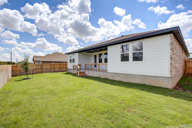 rear view of property featuring a lawn