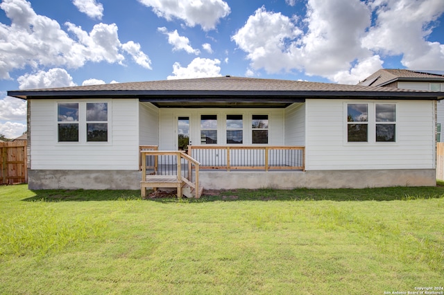 rear view of house with a lawn