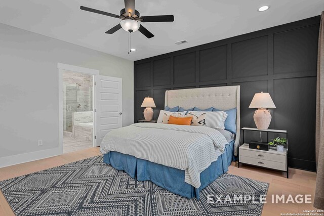 bedroom featuring ceiling fan, ensuite bathroom, and wood-type flooring