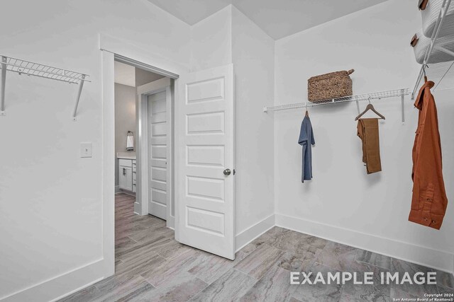 walk in closet featuring light hardwood / wood-style flooring