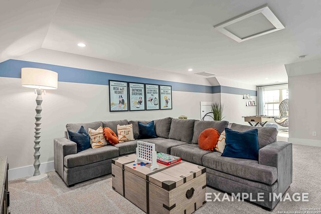 living room with lofted ceiling and light colored carpet