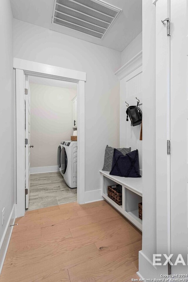 mudroom featuring washer and clothes dryer and light wood-type flooring