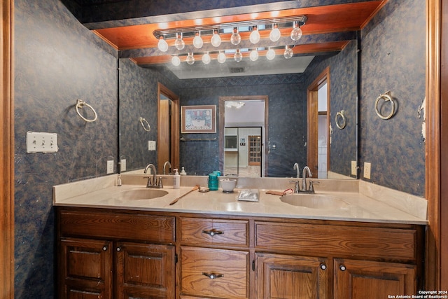 bathroom with beam ceiling and vanity