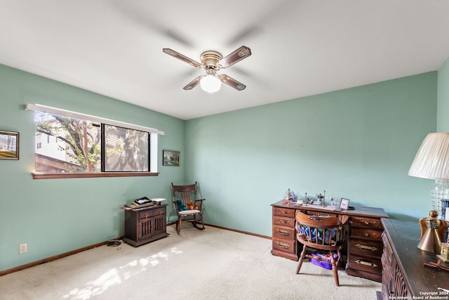 home office with ceiling fan and light carpet