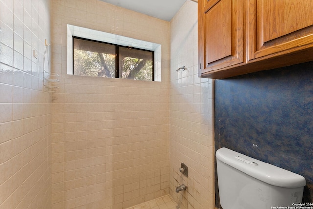 bathroom featuring toilet and tiled shower / bath