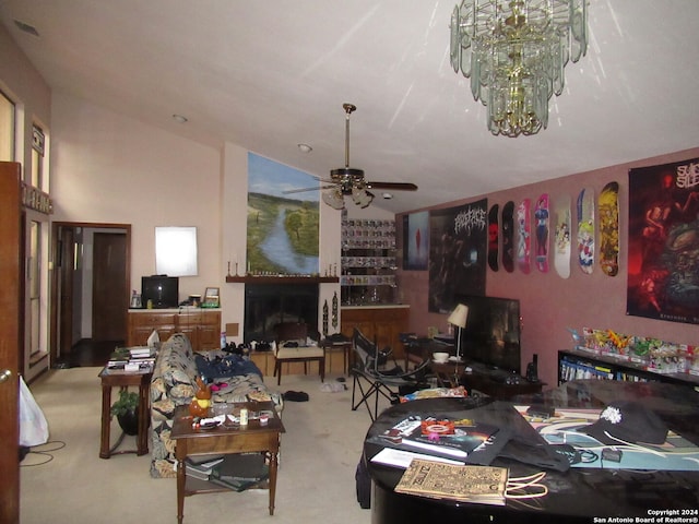 carpeted dining area featuring ceiling fan with notable chandelier