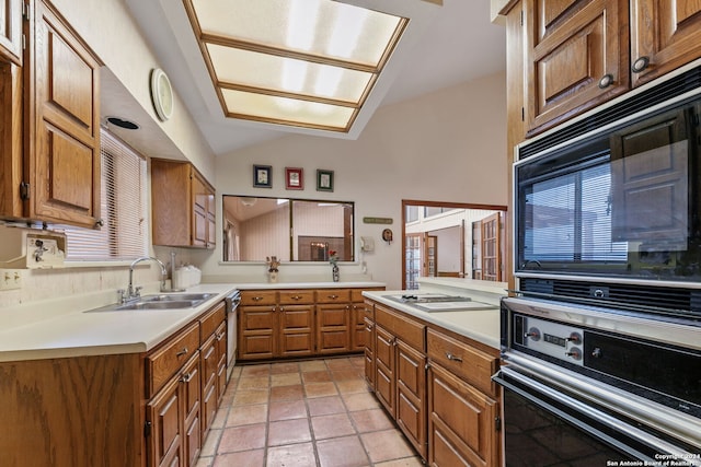 kitchen with black appliances, light tile patterned floors, sink, and vaulted ceiling