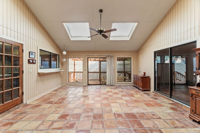 unfurnished sunroom with ceiling fan and vaulted ceiling