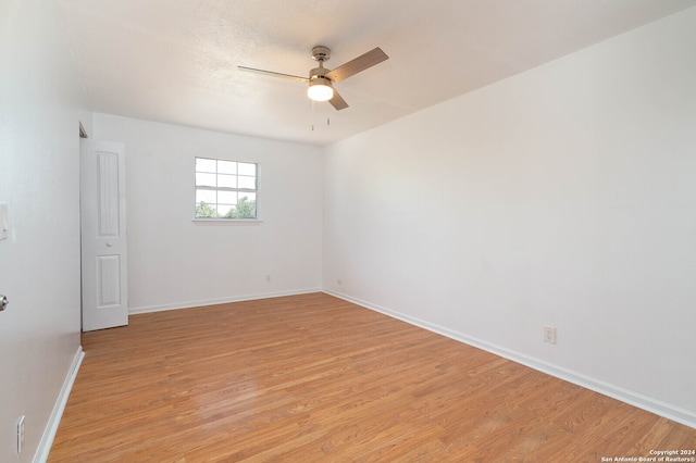 unfurnished room featuring ceiling fan and light hardwood / wood-style floors