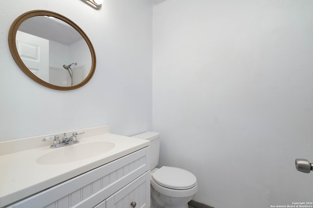 bathroom featuring toilet and large vanity