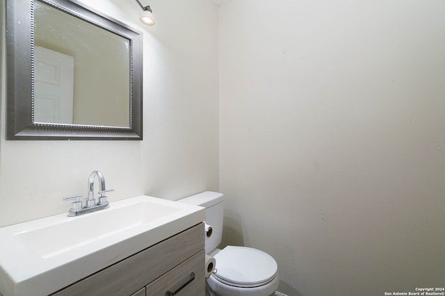 bathroom with toilet and vanity