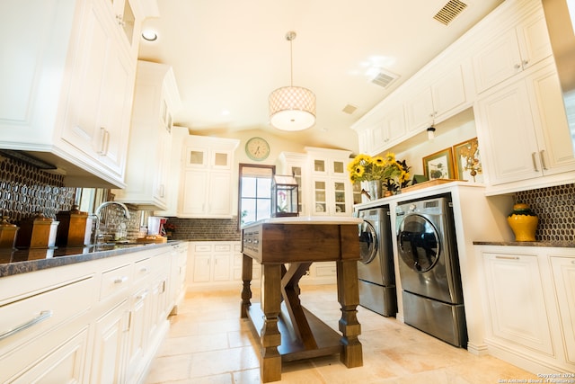 laundry room with independent washer and dryer and light tile patterned floors