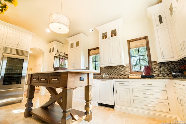 kitchen with light tile patterned floors, tasteful backsplash, and vaulted ceiling