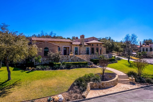 mediterranean / spanish-style home featuring a front lawn