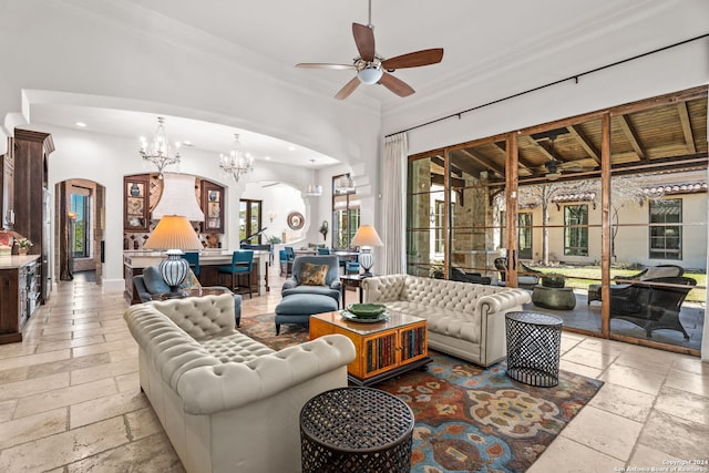 interior space featuring ceiling fan with notable chandelier