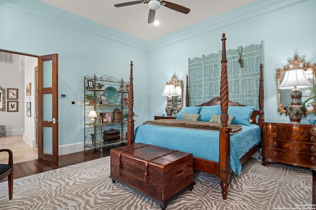 bedroom with ceiling fan, ornamental molding, and hardwood / wood-style flooring