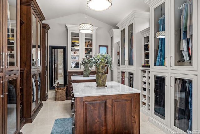 spacious closet with light tile patterned floors and lofted ceiling