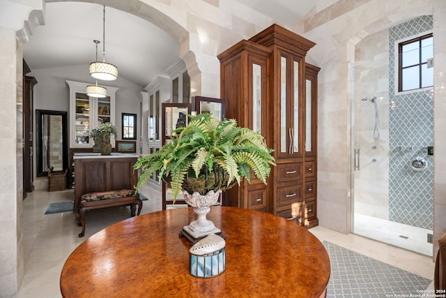 dining room with lofted ceiling and light tile patterned floors