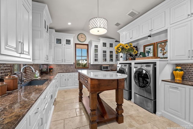 laundry area with light tile patterned flooring, sink, and independent washer and dryer