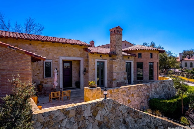 back of house with a patio