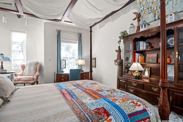 bedroom with beam ceiling