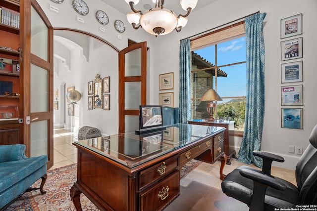 tiled home office featuring a notable chandelier