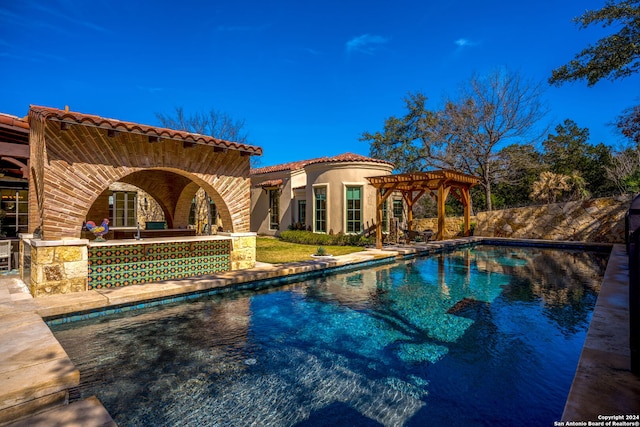 view of swimming pool featuring a pergola and a patio