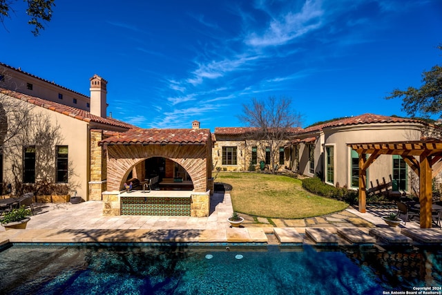 back of property featuring a pergola, a patio area, and a lawn