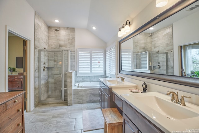 bathroom featuring vanity, shower with separate bathtub, and lofted ceiling