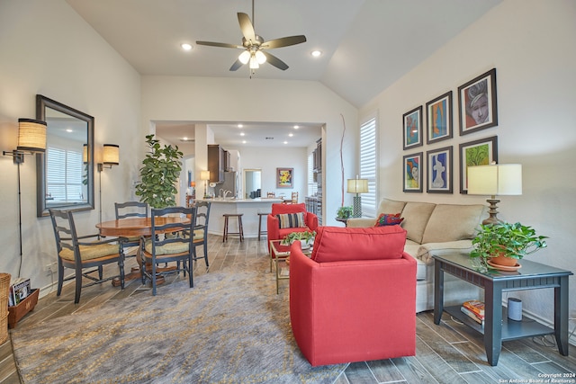 living room featuring vaulted ceiling, ceiling fan, and dark hardwood / wood-style flooring