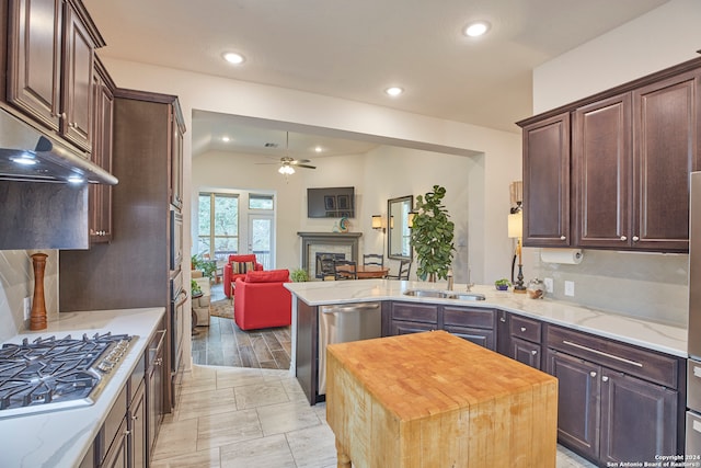 kitchen featuring a center island, sink, light hardwood / wood-style flooring, wooden counters, and ceiling fan