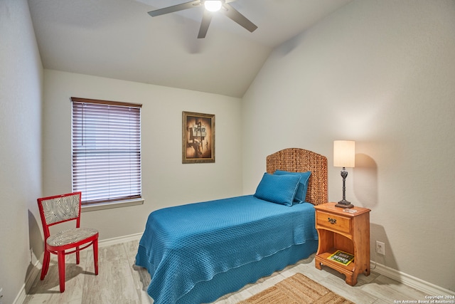 bedroom featuring light hardwood / wood-style flooring, lofted ceiling, and ceiling fan