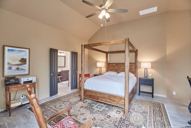 bedroom featuring light hardwood / wood-style floors, vaulted ceiling, ensuite bath, and ceiling fan