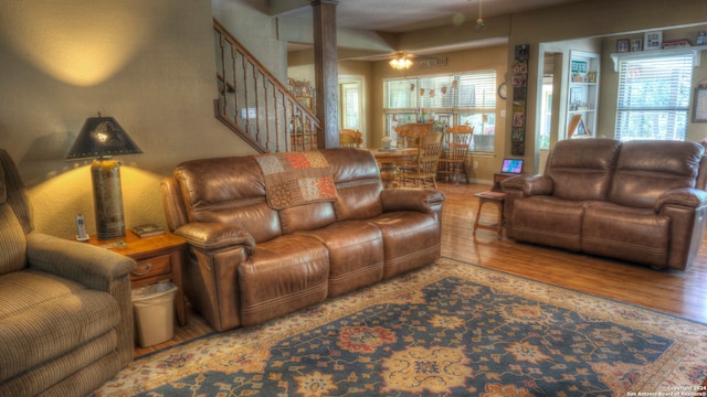 living room featuring light wood-type flooring and ornate columns