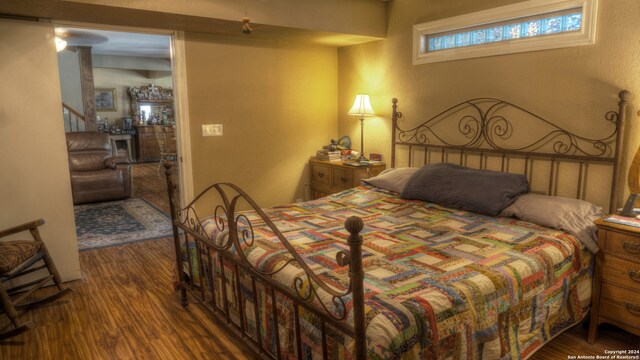 bedroom with dark wood-type flooring